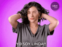 a woman winks and says yo soy linda in front of a salon line logo