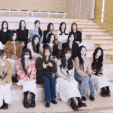 a group of women sitting on a set of stairs