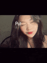 a woman with her eyes closed has the word put on her face .