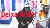 a man wearing a hat and sunglasses is standing in a room with the words deixa arder written in red