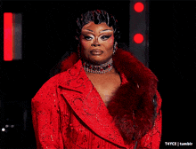 a woman in a red jacket screams with her arms outstretched