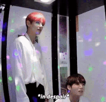 a man with red hair is standing next to another man and says " in despair "