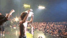 a crowd of people watching a concert with a man wearing a shirt that says ram