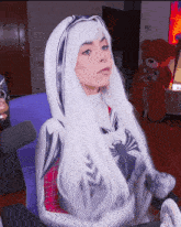a woman with long white hair is wearing a spiderman suit