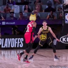 a basketball game is being played in front of an advertisement for microsoft