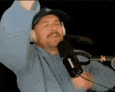 a man wearing headphones and a shure microphone is dancing