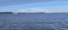 a large white cloud is coming out of the water .