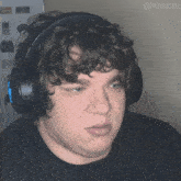 a man with curly hair wearing headphones with the name matchu on the bottom right