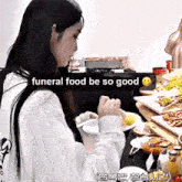 a woman is sitting at a table with plates of food and a caption that says funeral food be so good