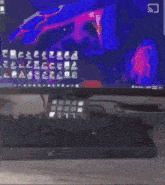 a person is sitting at a desk in front of a computer screen .