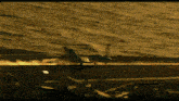 a fighter jet is taking off from the deck of an aircraft carrier .