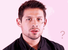 a man with a beard has a question mark behind his ear