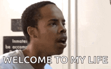 a man is making a funny face and saying welcome to my life