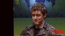 a man wearing a leather jacket with dungeons & dragons written on the bottom