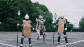 a group of people dressed up as a superhero are standing in a parking lot