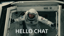 a man in a space suit says hello chat in front of an interstellar poster